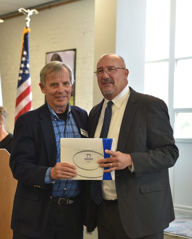 President Mitchell presenting Professor Peter Meggison with his 50-year service recognition.